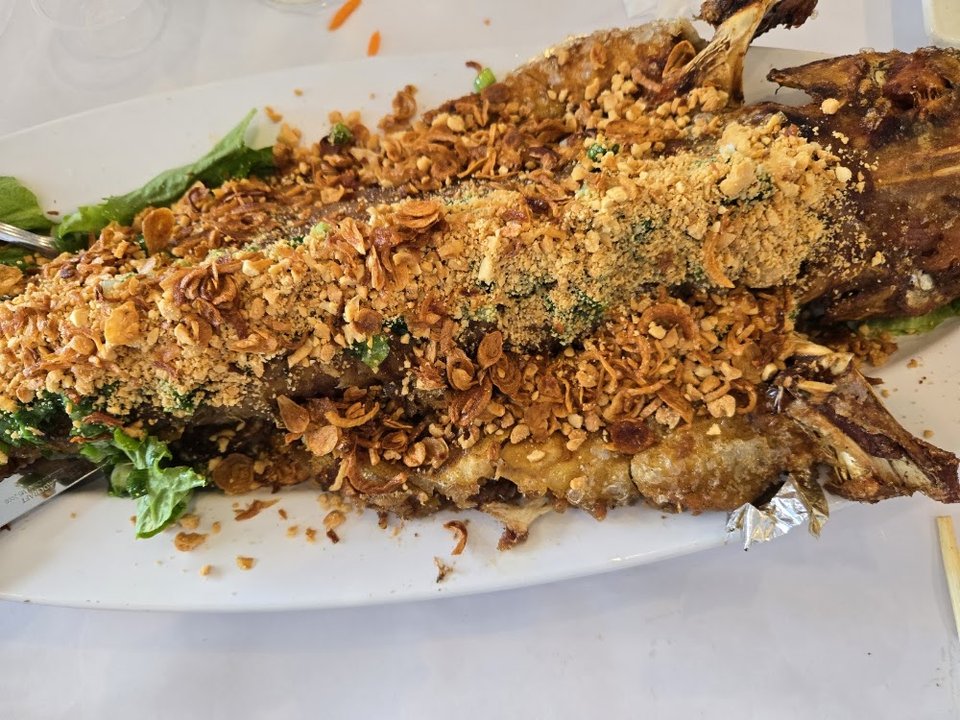 Seafood and rice dishes on a menu board.
