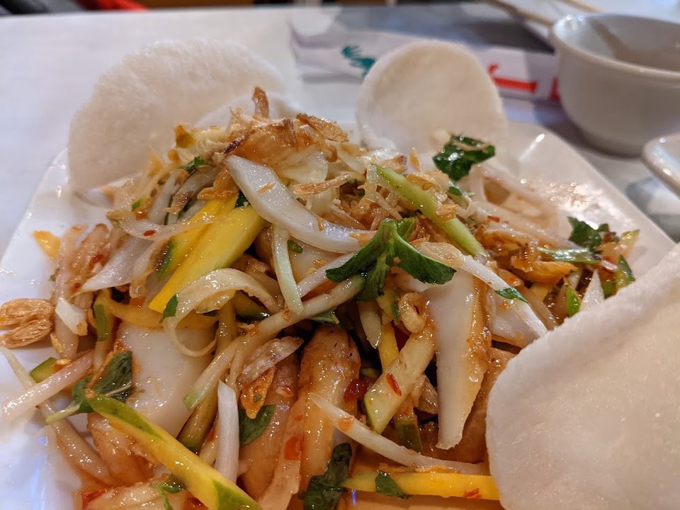 Seafood and rice dishes on a menu board.